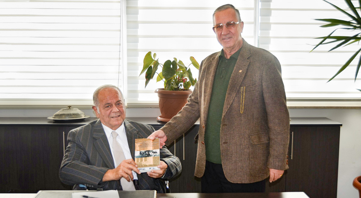 EMU-ATUM Chair Presents New Book to Acting President of EMU Board of Trustees